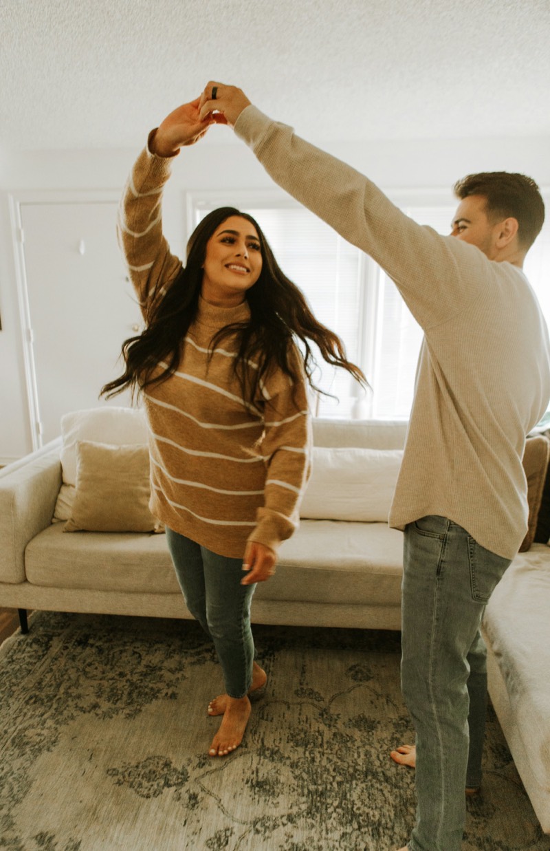A couple dancing in their living room